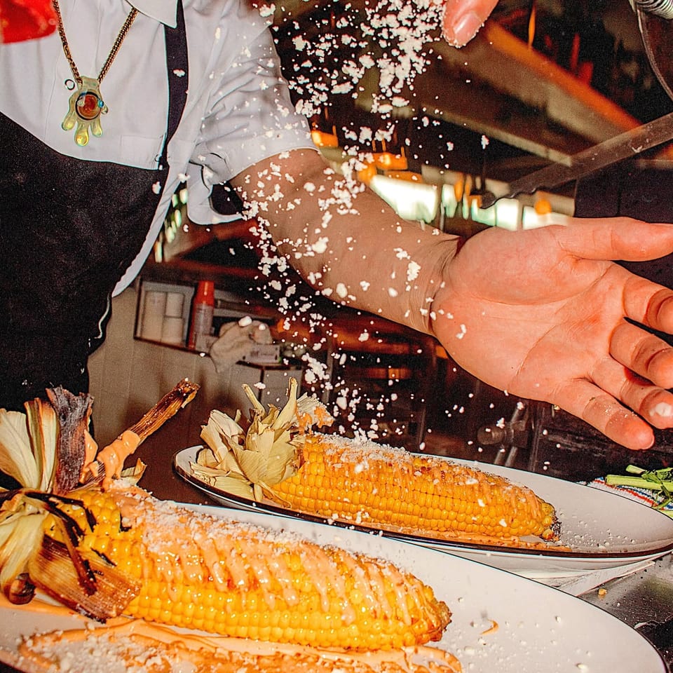 preparing grilled corn with cheese